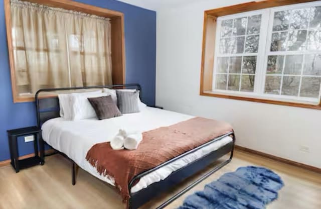 9439 Corneils Rd, Bristol, IL 60512 - bedroom featuring wood finished floors and baseboards