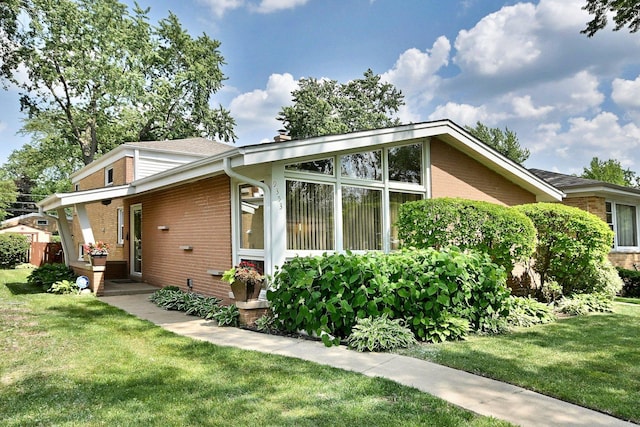 9353 Ewing Ave, Evanston, IL 60203 - view of side of property featuring brick siding and a lawn