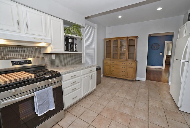 1107 W Lafayette St, Ottawa, IL 61350 - kitchen featuring gas range, under cabinet range hood, freestanding refrigerator, open shelves, and backsplash