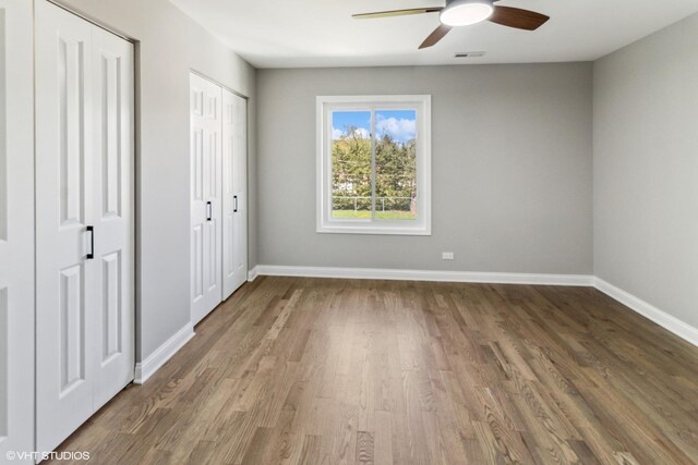 524 Willow St, Itasca, IL 60143 - unfurnished bedroom with wood finished floors, two closets, and ceiling fan
