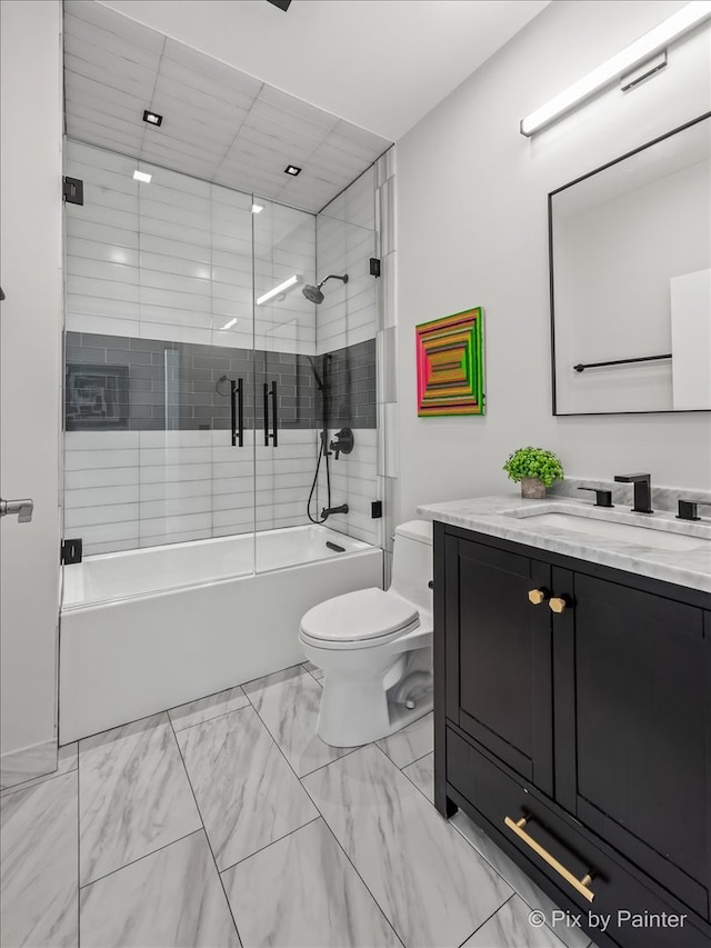 653 N Kingsbury St Unit 706, Chicago, IL 60654 - bathroom with vanity, shower / bath combination with glass door, and marble look tiles