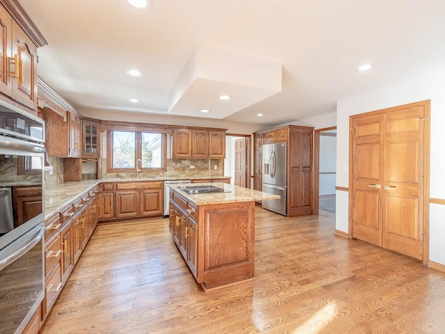 501 Bryan Trl, New Lenox, IL 60451 - kitchen with appliances with stainless steel finishes, light stone counters, tasteful backsplash, a kitchen island, and recessed lighting