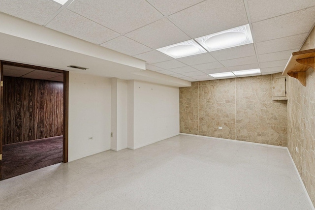 12 N Waterford Dr Unit 0, Schaumburg, IL 60194 - finished below grade area with a drop ceiling, tile patterned floors, and wood walls