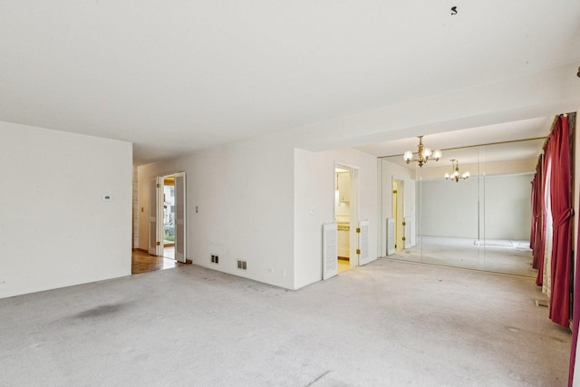 12 N Waterford Dr Unit 0, Schaumburg, IL 60194 - unfurnished living room featuring light colored carpet and a chandelier