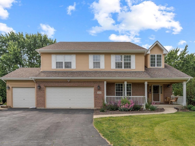 16260 W Mohawk Ct, Lockport, IL 60441 - traditional home with asphalt driveway, a front yard, a porch, and brick siding