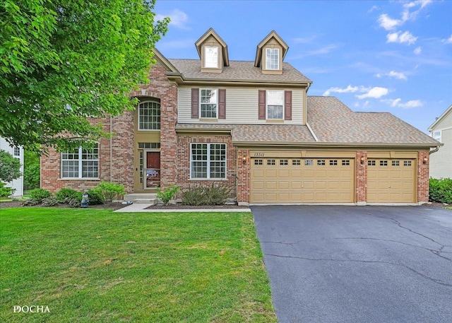 13311 Morning Mist Pl, Plainfield, IL 60585 - view of front facade with a front lawn, asphalt driveway, a garage, a shingled roof, and brick siding