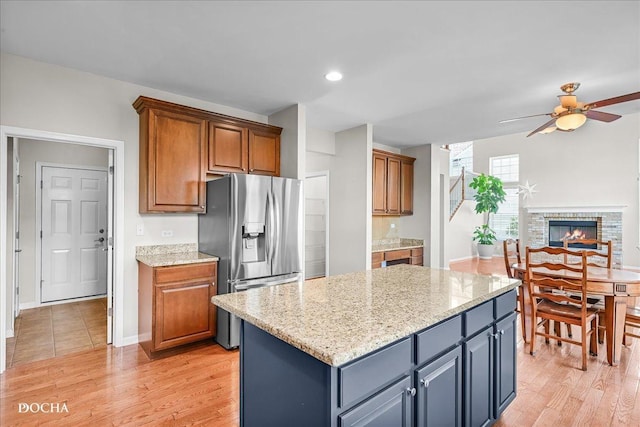 13311 Morning Mist Pl, Plainfield, IL 60585 - kitchen with stainless steel fridge, a ceiling fan, light wood-style flooring, a kitchen island, and recessed lighting