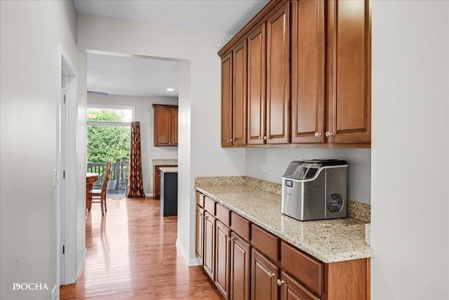 13311 Morning Mist Pl, Plainfield, IL 60585 - kitchen featuring light wood-style flooring, brown cabinets, and light stone countertops