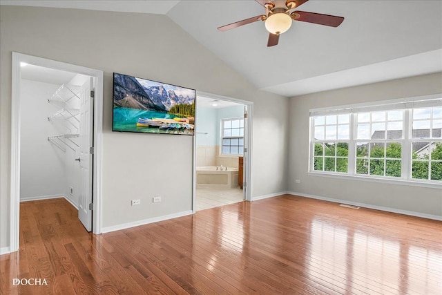 13311 Morning Mist Pl, Plainfield, IL 60585 - unfurnished bedroom featuring vaulted ceiling, wood finished floors, a walk in closet, ensuite bath, and ceiling fan