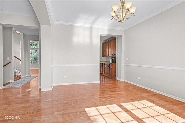 13311 Morning Mist Pl, Plainfield, IL 60585 - empty room with light wood-type flooring, stairs, a chandelier, and ornamental molding