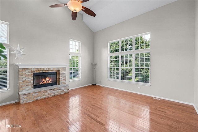 13311 Morning Mist Pl, Plainfield, IL 60585 - unfurnished living room with a ceiling fan, hardwood / wood-style flooring, high vaulted ceiling, and a brick fireplace