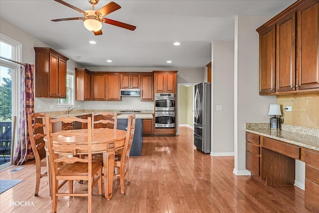 13311 Morning Mist Pl, Plainfield, IL 60585 - kitchen featuring appliances with stainless steel finishes, ceiling fan, light wood-style flooring, brown cabinets, and recessed lighting