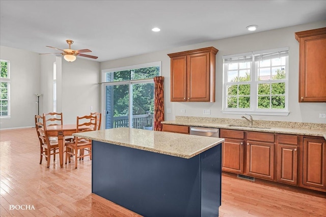 13311 Morning Mist Pl, Plainfield, IL 60585 - kitchen with light wood-style flooring, plenty of natural light, brown cabinetry, a center island, and recessed lighting