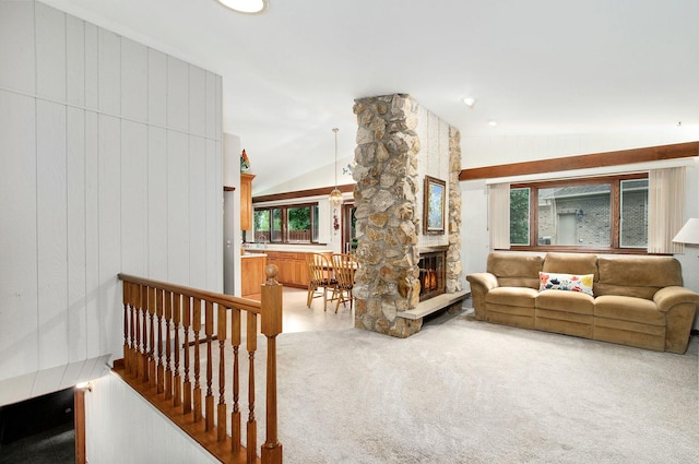 440 E Walnut St, Roselle, IL 60172 - living room featuring vaulted ceiling, light colored carpet, a stone fireplace, and healthy amount of natural light
