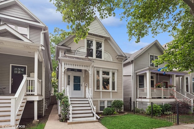 4848 N Seeley Ave, Chicago, IL 60625 - victorian-style house featuring a balcony, covered porch, and stairs