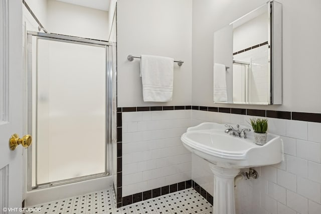 4848 N Seeley Ave, Chicago, IL 60625 - bathroom with tile walls, a shower stall, and wainscoting