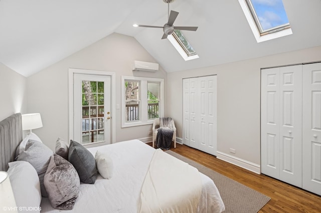 4848 N Seeley Ave, Chicago, IL 60625 - bedroom featuring a skylight, multiple closets, a wall mounted air conditioner, wood finished floors, and vaulted ceiling