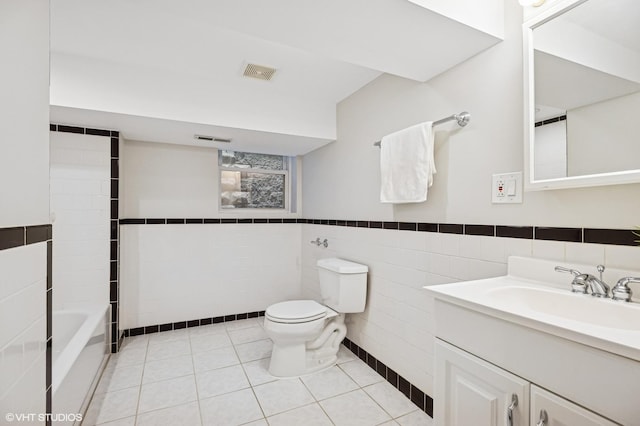 4848 N Seeley Ave, Chicago, IL 60625 - bathroom featuring tile walls, vanity, a wainscoted wall, and tile patterned floors
