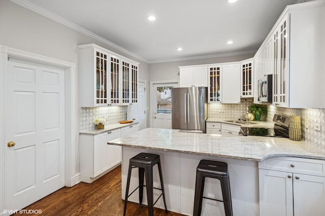 4848 N Seeley Ave, Chicago, IL 60625 - kitchen with stainless steel appliances, decorative backsplash, a peninsula, crown molding, and white cabinets