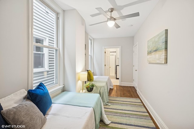 4848 N Seeley Ave, Chicago, IL 60625 - bedroom featuring wood finished floors, multiple windows, connected bathroom, and a ceiling fan