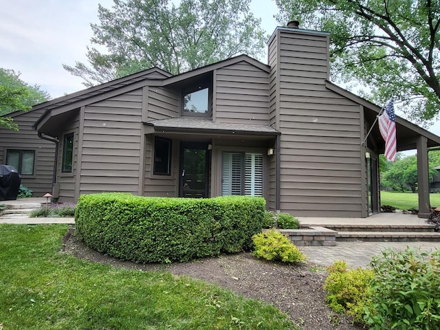 63 Lakewood Cir Unit 63, Saint Charles, IL 60174 - view of home's exterior with a chimney and a yard