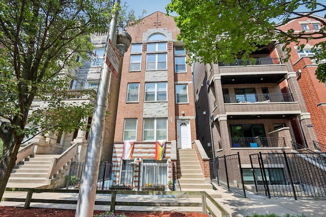 3522 N Fremont St Unit 2, Chicago, IL 60657 - view of apartment building / complex with stairs and a fenced front yard