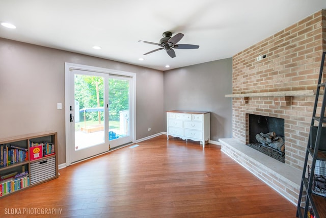 106 Grand Central Ln, Schaumburg, IL 60193 - unfurnished living room featuring wood finished floors, a fireplace, a ceiling fan, and recessed lighting