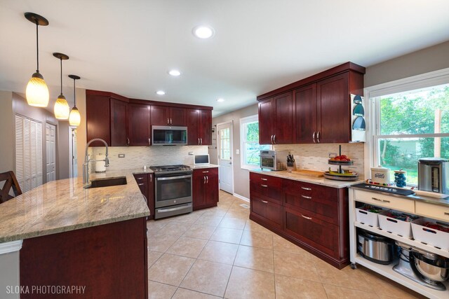 106 Grand Central Ln, Schaumburg, IL 60193 - kitchen with appliances with stainless steel finishes, backsplash, light stone counters, recessed lighting, and decorative light fixtures
