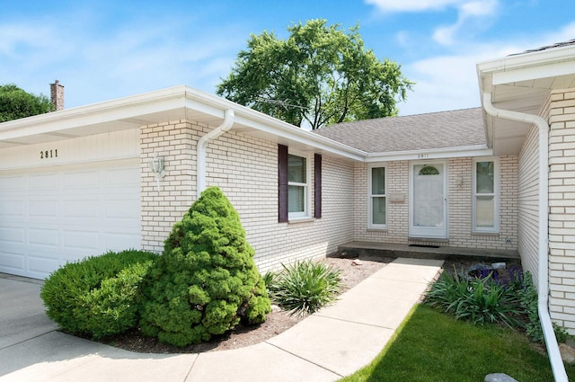 2811 N Harvard Ave, Arlington Heights, IL 60004 - property entrance featuring a garage, brick siding, and roof with shingles