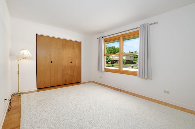 2811 N Harvard Ave, Arlington Heights, IL 60004 - unfurnished bedroom with wood finished floors, a closet, and a baseboard radiator