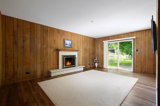 2811 N Harvard Ave, Arlington Heights, IL 60004 - unfurnished living room with hardwood / wood-style floors, a brick fireplace, and wood walls
