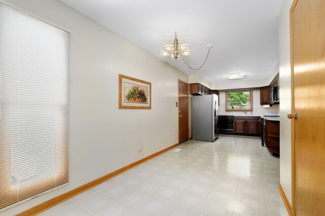 2811 N Harvard Ave, Arlington Heights, IL 60004 - kitchen featuring freestanding refrigerator, stove, black dishwasher, a chandelier, and light countertops