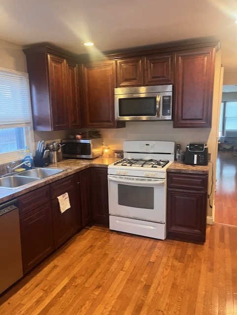 6839 S Michigan Ave, Chicago, IL 60637 - kitchen featuring appliances with stainless steel finishes, light wood finished floors, dark brown cabinets, and light countertops
