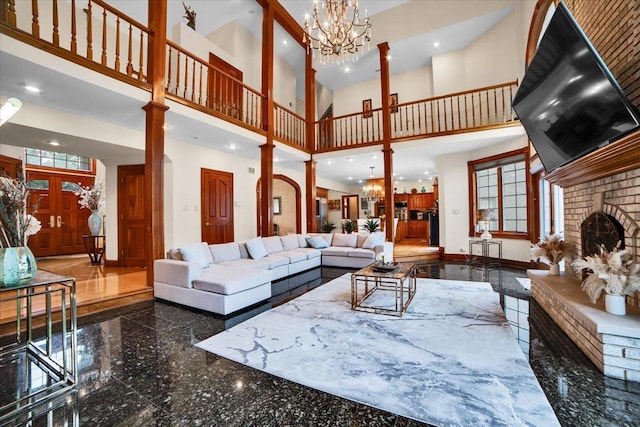 14695 Fox Hollow Ln, Lemont, IL 60439 - living room with a towering ceiling, granite tiled floors, a chandelier, a brick fireplace, and recessed lighting