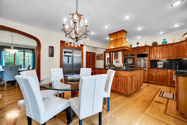 14695 Fox Hollow Ln, Lemont, IL 60439 - dining room with a chandelier, recessed lighting, light wood-style flooring, and arched walkways