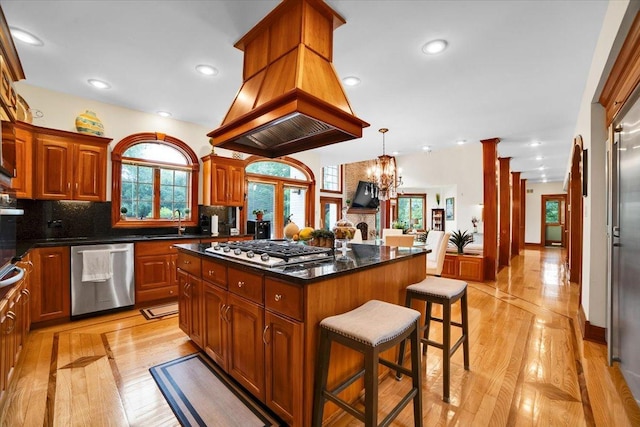 14695 Fox Hollow Ln, Lemont, IL 60439 - kitchen featuring stainless steel appliances, a breakfast bar area, premium range hood, decorative backsplash, and a kitchen island