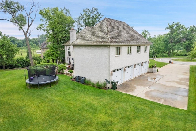 14695 Fox Hollow Ln, Lemont, IL 60439 - view of side of property featuring a trampoline, a chimney, a yard, and a garage