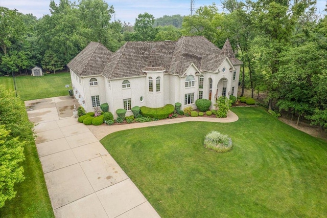 14695 Fox Hollow Ln, Lemont, IL 60439 - french country home featuring a front lawn, stucco siding, an outbuilding, and concrete driveway