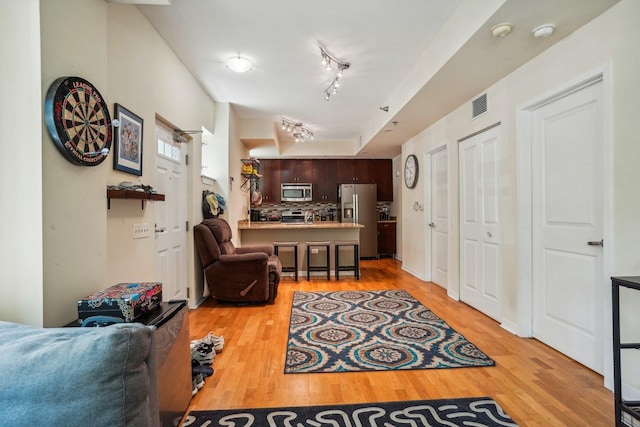 1159 N Hudson St Unit 1-101, Chicago, IL 60610 - living area with light wood-style floors and track lighting