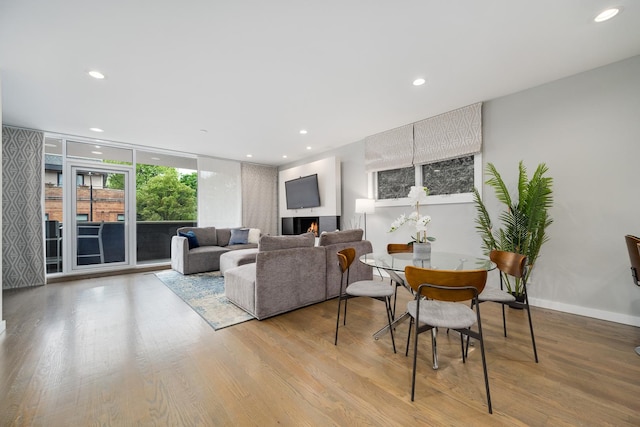 927 N Damen Ave Unit 2, Chicago, IL 60622 - living room with wood finished floors, recessed lighting, and a wall of windows