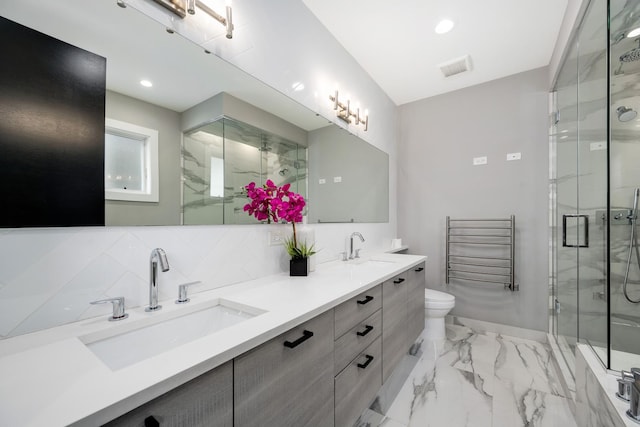 927 N Damen Ave Unit 2, Chicago, IL 60622 - full bathroom featuring marble finish flooring, a marble finish shower, double vanity, a towel warming rack, and tasteful backsplash
