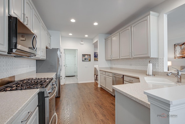3181 Rockwell Cir, Mundelein, IL 60060 - kitchen with stainless steel appliances, dark wood-type flooring, recessed lighting, backsplash, and light countertops