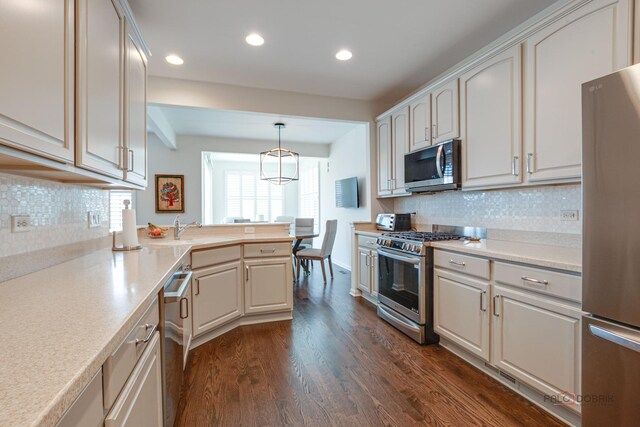 3181 Rockwell Cir, Mundelein, IL 60060 - kitchen with stainless steel appliances, recessed lighting, dark wood-type flooring, backsplash, and light countertops