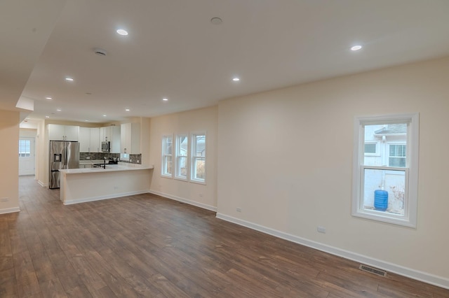 1131 S Ridgeland Ave, Oak Park, IL 60304 - unfurnished living room with dark wood-style floors, healthy amount of natural light, and recessed lighting
