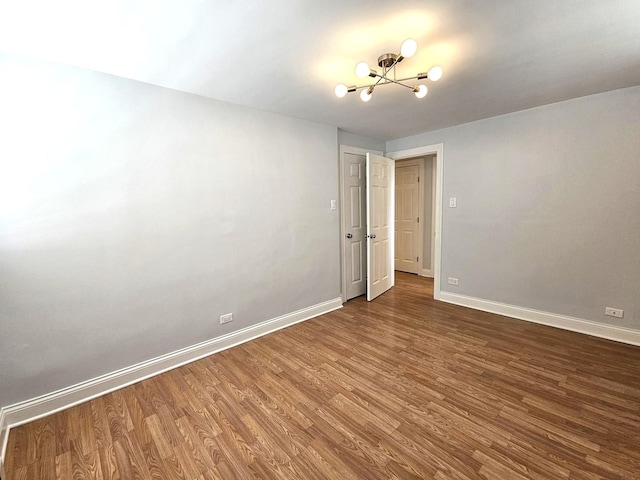 2624 W Catalpa Ave Unit 14, Chicago, IL 60625 - empty room with wood finished floors and a chandelier