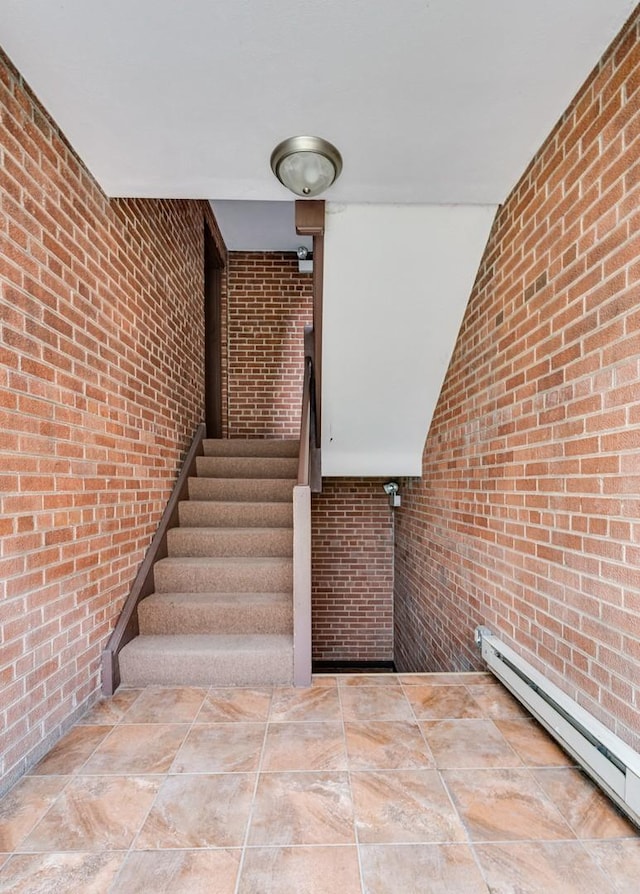 2624 W Catalpa Ave Unit 14, Chicago, IL 60625 - stairway featuring brick wall and a baseboard radiator
