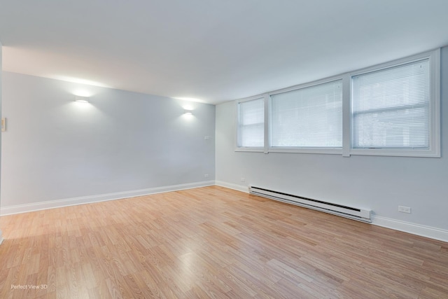 2624 W Catalpa Ave Unit 14, Chicago, IL 60625 - unfurnished room featuring a baseboard heating unit and wood finished floors