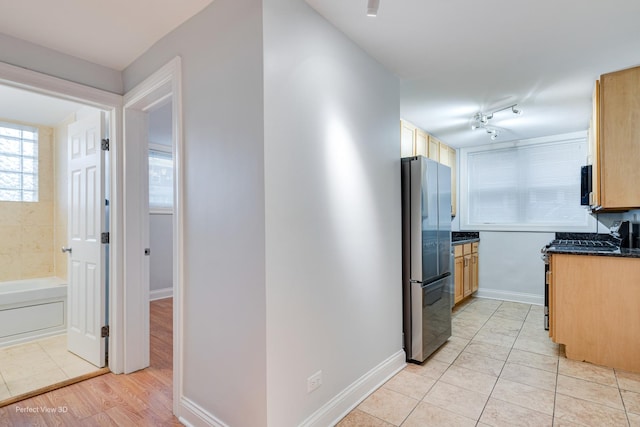 2624 W Catalpa Ave Unit 14, Chicago, IL 60625 - kitchen with appliances with stainless steel finishes, dark countertops, and light tile patterned flooring