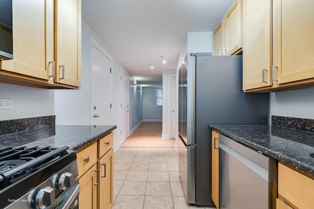 2624 W Catalpa Ave Unit 14, Chicago, IL 60625 - kitchen featuring appliances with stainless steel finishes, light tile patterned floors, light brown cabinets, and dark stone countertops