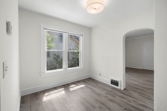 3225 Gilead Ave, Zion, IL 60099 - spare room with arched walkways and wood finished floors